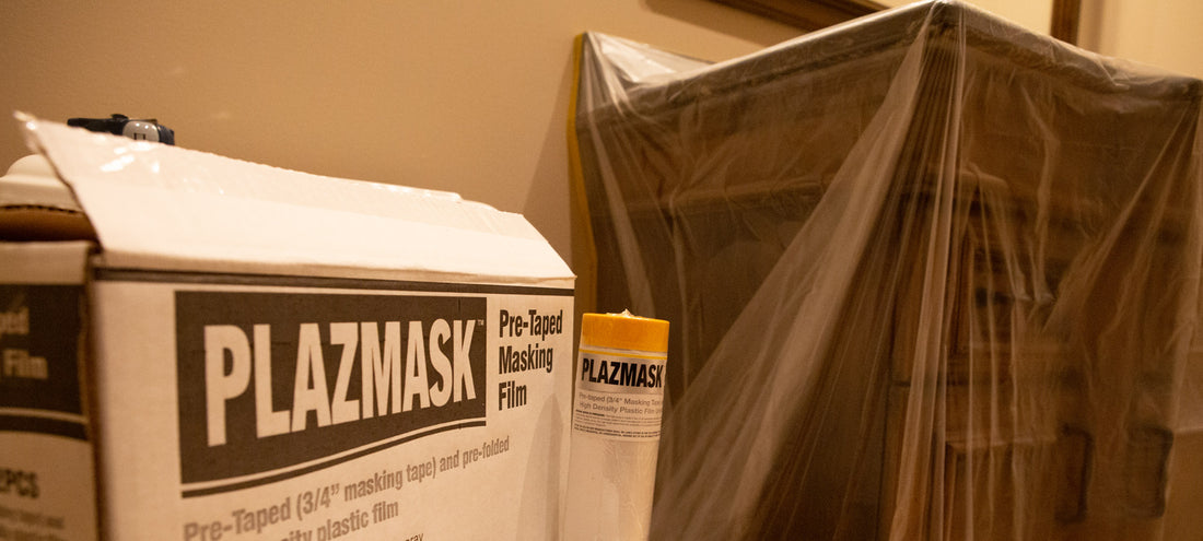 A banner image that shows a box of PlazMask Pre-Taped Masking Film in the left foreground. A roll of the protective film can be seen beside the box. A covered bathroom vanity is in the background.